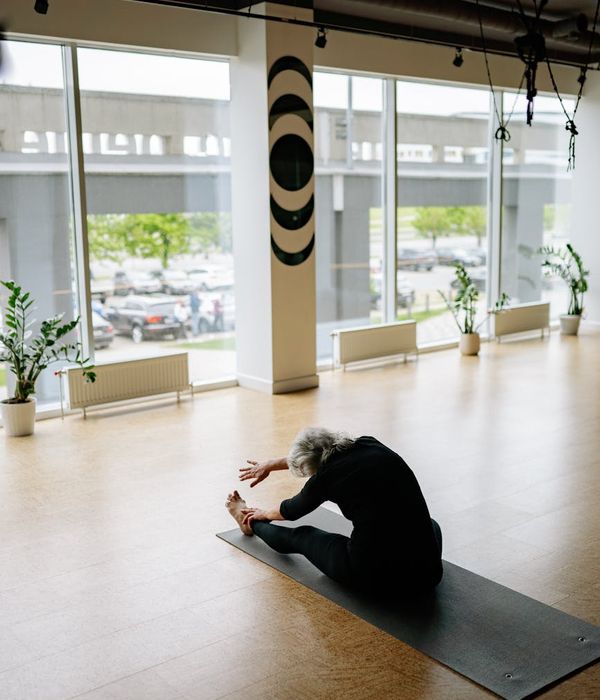 Woman practicing yoga for flexibility in a modern studio